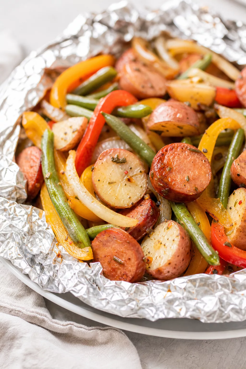Sausage and Potato Foil Packets served in a cozy home kitchen