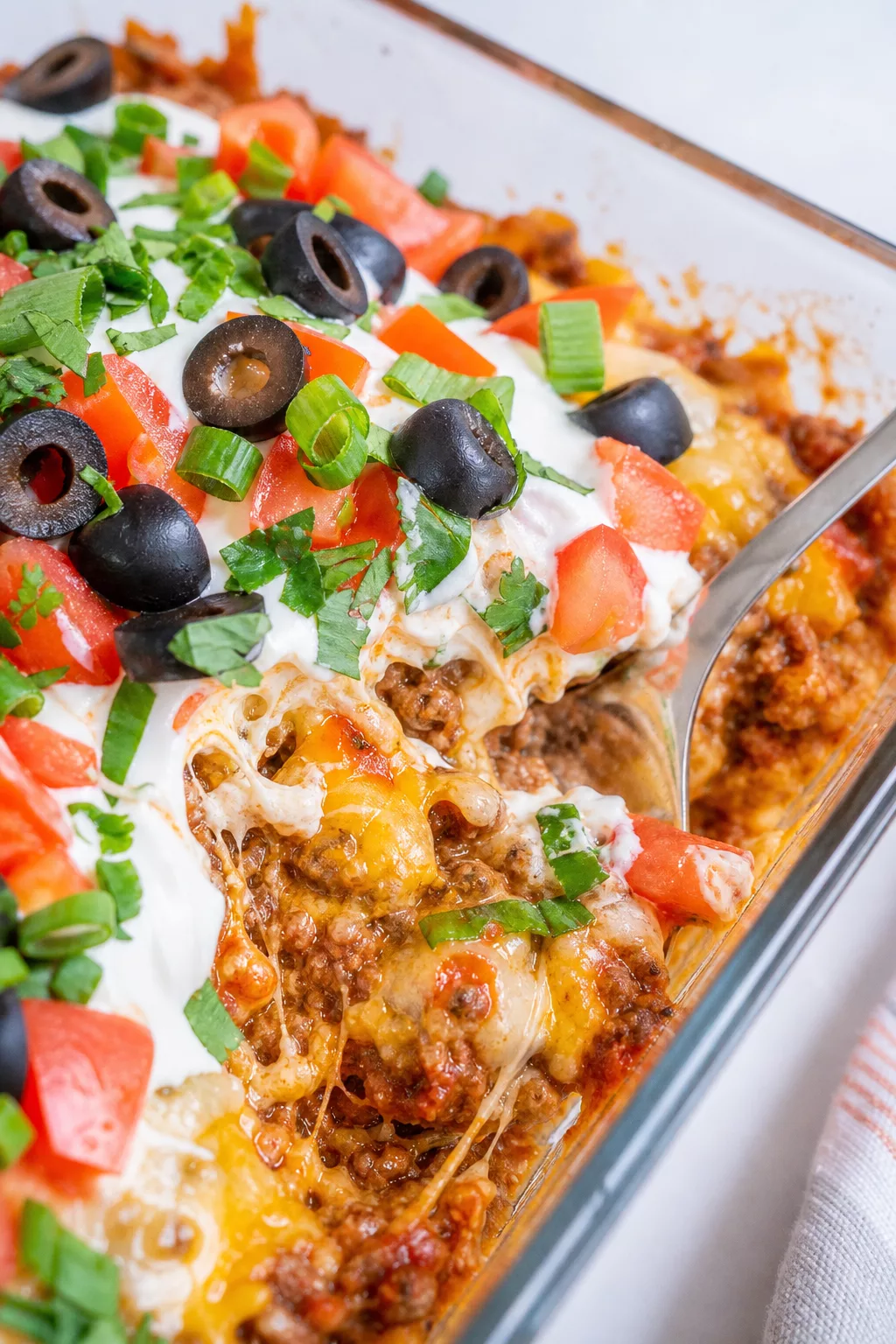 Cheesy Baked Mexican Dip close-up serving shot