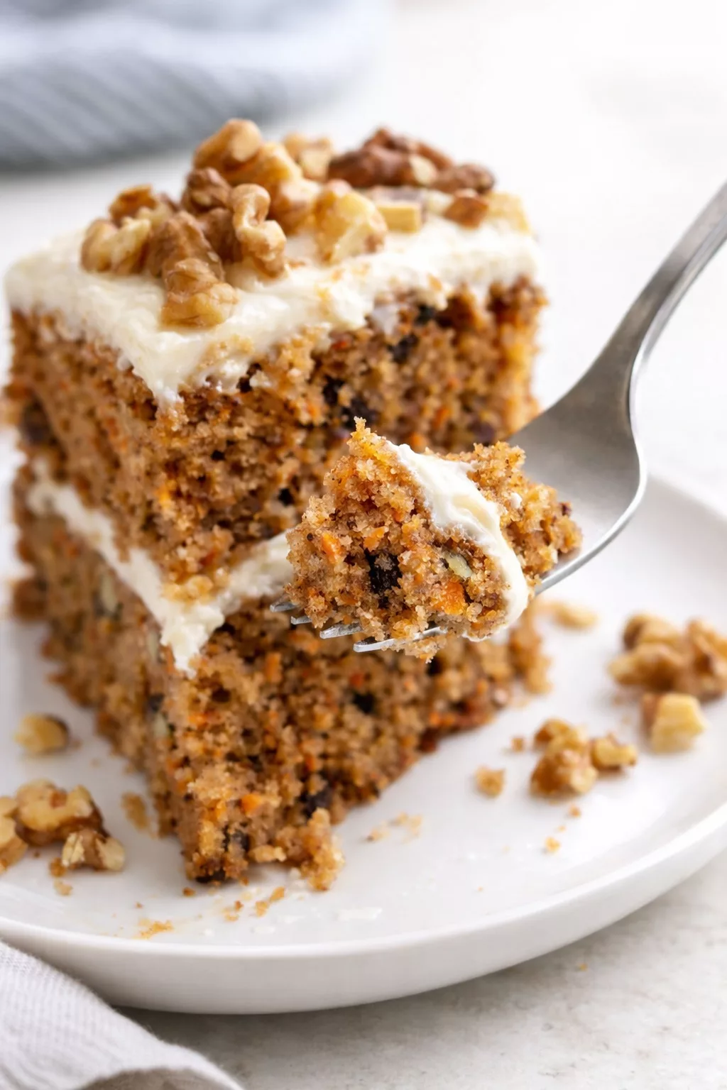 Moist Carrot Cake with Cream Cheese Frosting close-up serving shot
